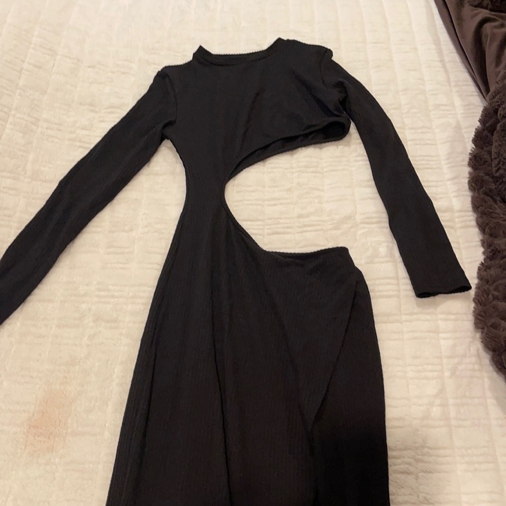 long black dress with a slit on the bottom and a cut out detail in the stomach.
